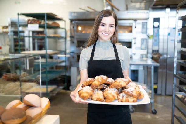 istock Worker selling pastries in bakery shop 1216280346