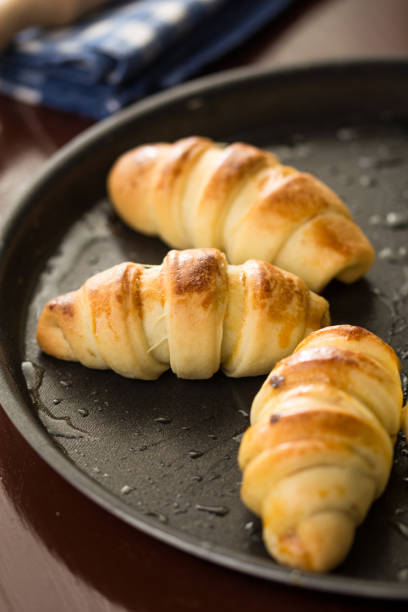 istock Closeup macro of baked rolls on the baking tray with selective focus 1216280731