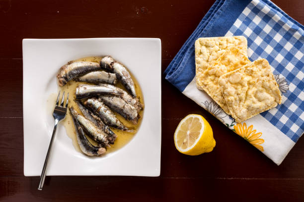 istock Marinated sardines in the oil served with lemon and corn bread 1216281650