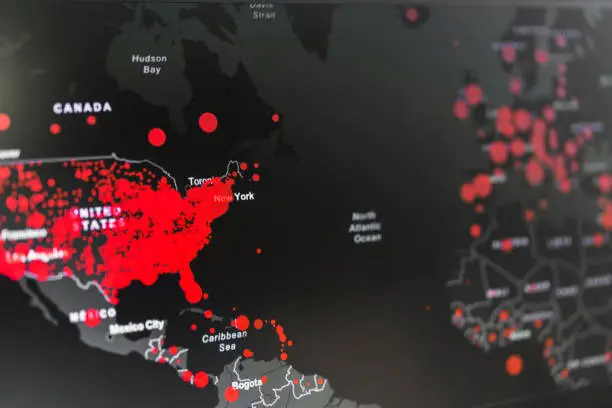 Photo of World map showing the spread of coronavirus covid-19 pandemic virus, focus on the USA