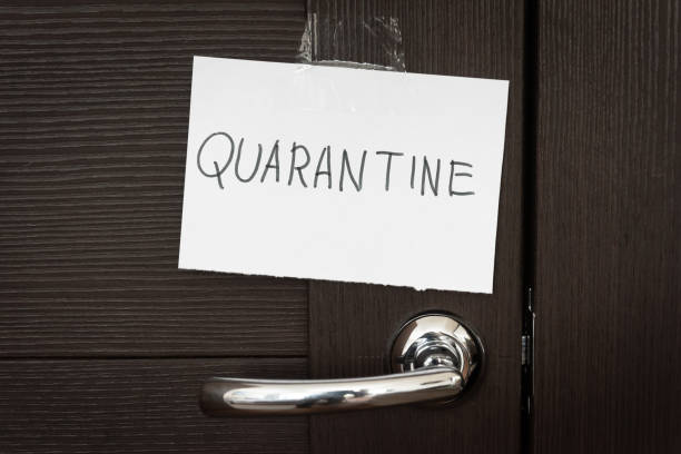 istock COVID-19 coronavirus concept, closed door with handle and note Quarantine. SARS-CoV-2 corona virus outbreak. 1216283263