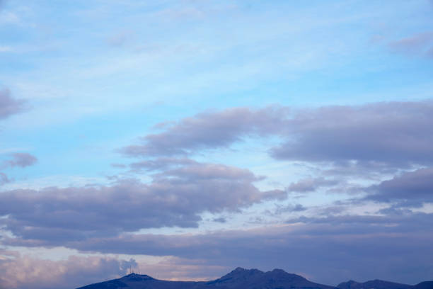 yellow and orange clouds at sunset. dramatic sky skyline background with mountain