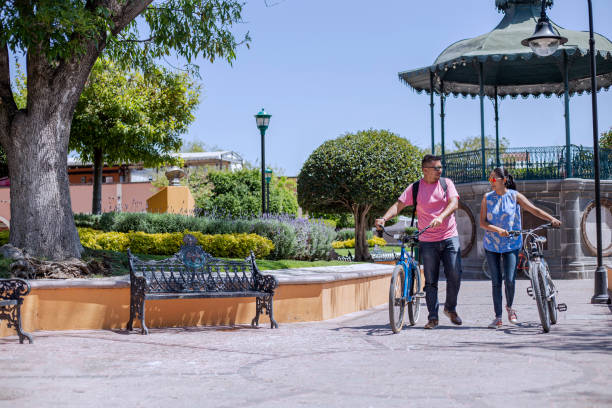 Latino couple, biking in Tequisquiapan, Queretaro, Mexico