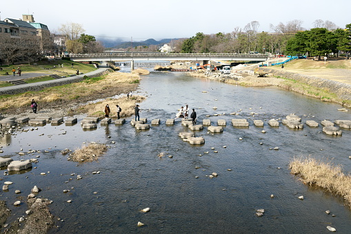 Kyoto,Japan-February 27, 2020: Turtle-shaped stepping stones that cross the Kamogawa river in Kyoto