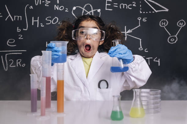 istock surprised scientist child in lab coat with flasks 1216291730
