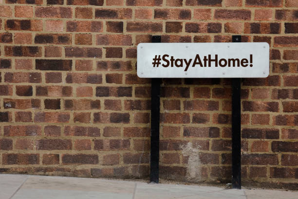 istock Stay at Home hashtag with a road banner 1216297909
