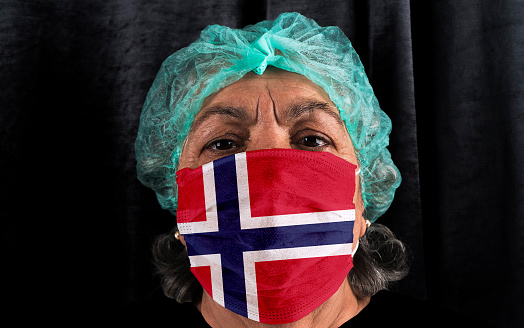 Coronavirus covid-19 old woman doctor flag mask