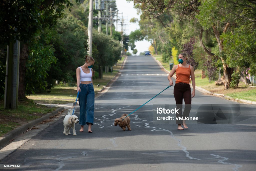 Australian Adults COVID 19 Social Distancing Two women using social distancing in the community. Family Pets, and living in lockdown. Melbourne - Australia Stock Photo