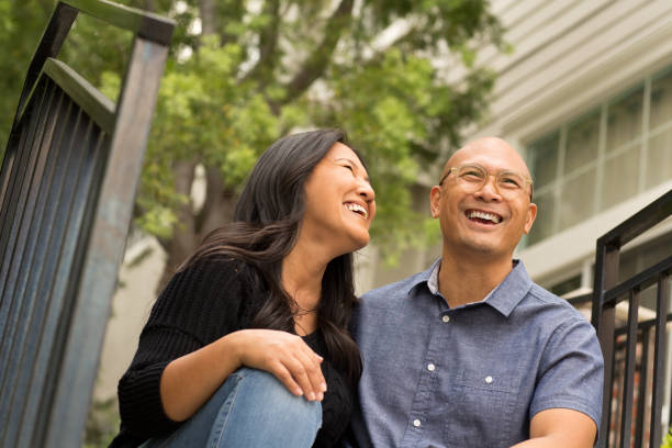 istock Happy Asian couple smiling and hugging outside. 1216302809
