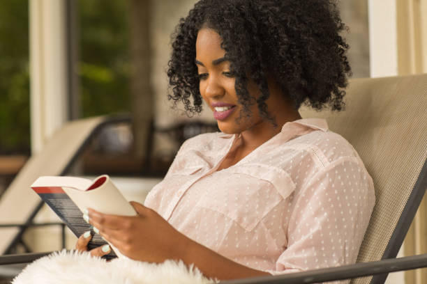 istock African American woman reading a book. 1216303685