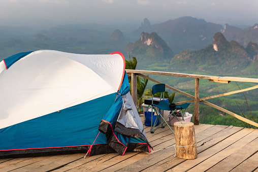 Landscape Scenery Mountains View With Camping Tent on Wooden Terrace for Outdoors Leisure Activity Relaxation. Beautiful Scenic of Nature From Campsite Viewpoint, Adventure/Vacation Lifestyle Concept.