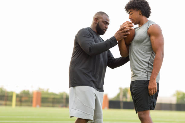 istock American Football coach training a young athlete. 1216304573
