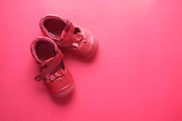 istock Baby shoes on red background, top view 1216308986