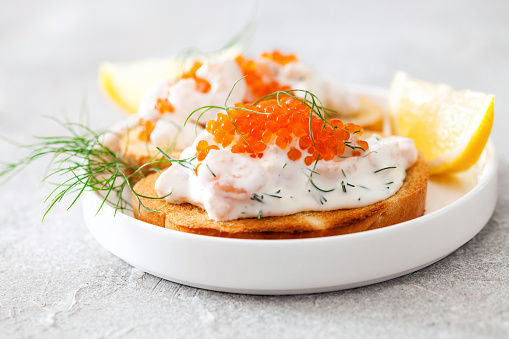 Toast skagen - shrimp and caviar on toast. Classic swedish appetizer. Selective focus. Copy space