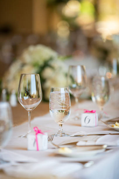 istock Wedding table setting with ice water filled glass and small gift boxes for the guests 1216312302