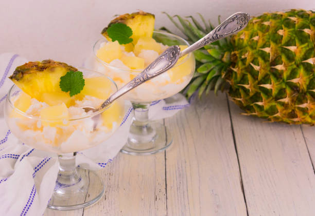 Pineapple ice cream in a glass bowl .