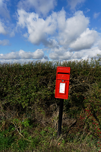 Northall, Bedfordshire/England - October 19, 2019: A British Royal Mail red post box in a country lane.