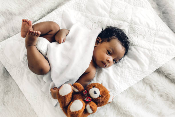 portrait of cute adorable little african american baby sleep in a white bedroom - family american culture african culture black imagens e fotografias de stock