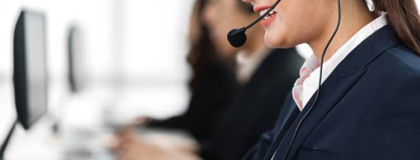 Beautiful businesswoman customer support services working with headset and computer at call center stock photo