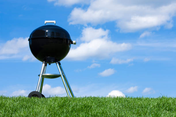 istock Black Barbecue Grill against a Blue Sky 1216317813
