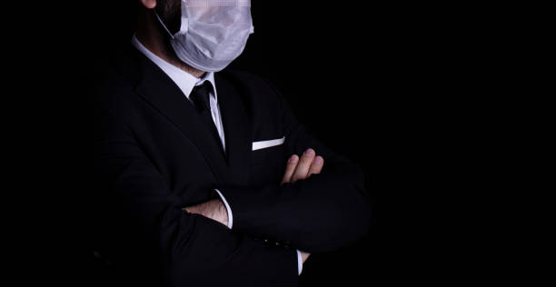 istock businessman with a pollution mask fighting the flu or virus 1216317854
