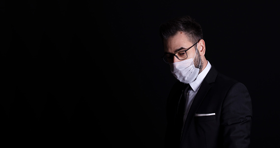 businessman with a pollution mask fighting the flu or virus