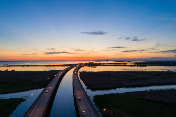 Sunset sky over Mobile Bay Aerial view of Mobile Bay, Alabama at sunset mobile bay stock pictures, royalty-free photos & images