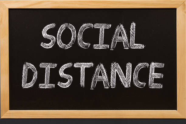 istock Social distance text on blackboard 1216322782