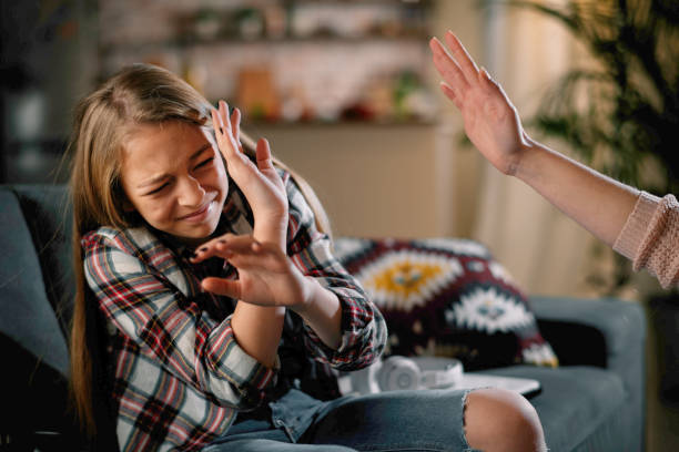 Mother slapping her daughter. stock photo