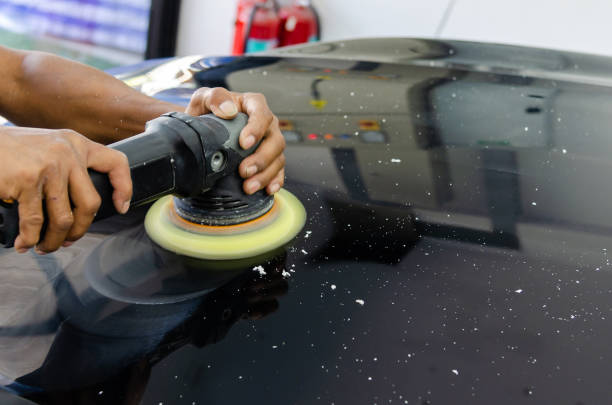 istock hands holding the work tool polish car. 1216324658