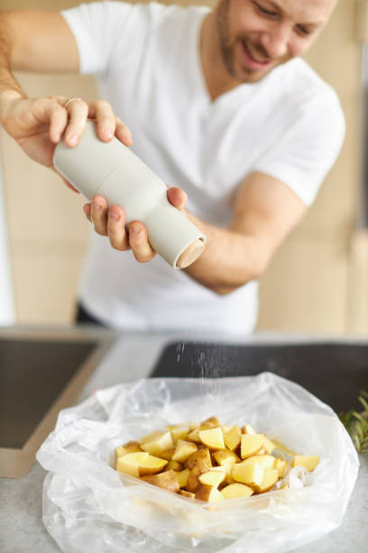 various photos of a young man wearing a white t-shirt cooking healthy food in a great design kitchen - gourmet enjoyment food freshness imagens e fotografias de stock