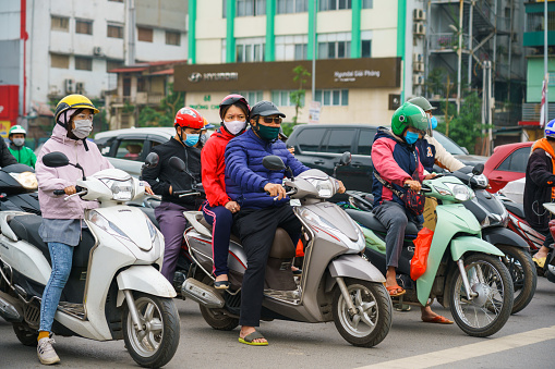 Hanoi, Vietnam - Apr 1, 2020 : People on street wearing face mask to protect against covid-19 coronavirus during outbreak pandemic on Truong Chinh street