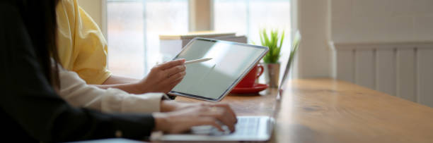 istock Side view of two college girl working on their assignment in comfortable workspace 1216327384