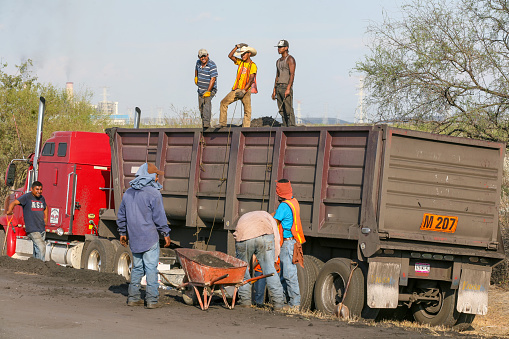 Piedras Negras, Mexico, September 26 -- Some Mexicans miners load coal onto a truck outside Piedras Negras, a town near the boundary between the state of Coahuila in Mexico and Texas in the United States.
