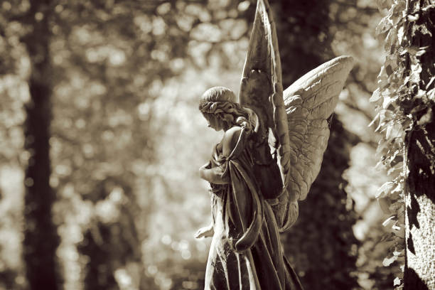istock Antique Angel statue in a Cemetery 1216329979