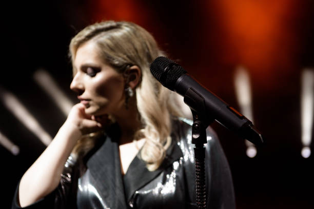 istock Singer woman on stage. Singer and microphone. 1216331914