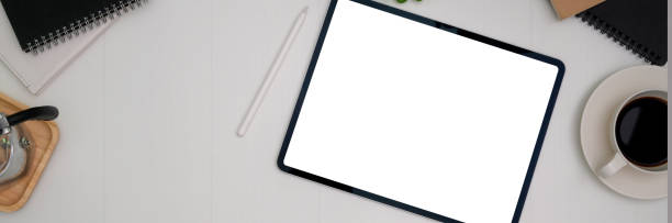 istock Top view of simple workspace with mock-up tablet, coffee cup and copy space 1216332391