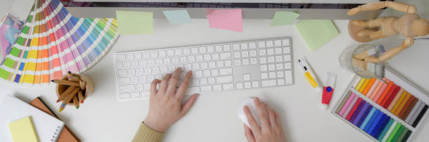 istock Overhead shot of female designer typing on computer keyboard on white table 1216332416