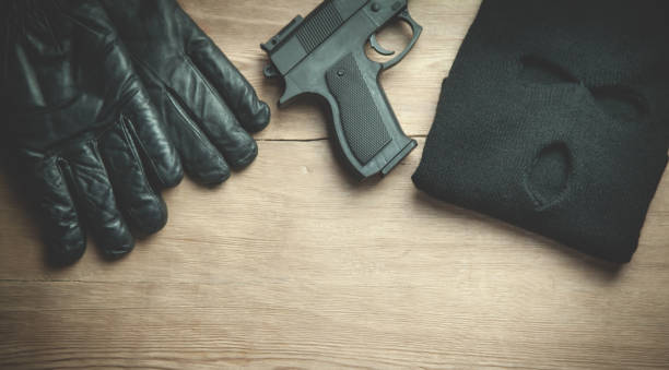 istock Pistol, mask, gloves on wooden background. 1216337547