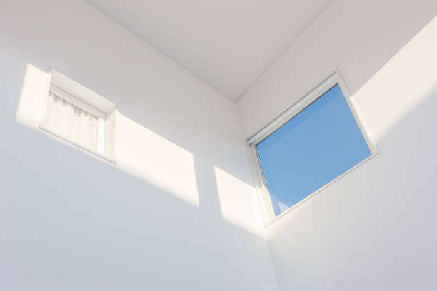 istock Looking up to the blue sky through modern square ceiling window 1216338399