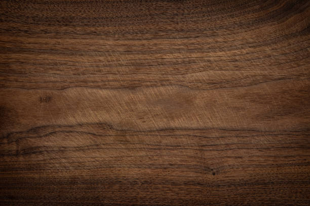 istock Walnut wooden chopping board texture background. Old wooden chopping board with knife pattern. 1216341984