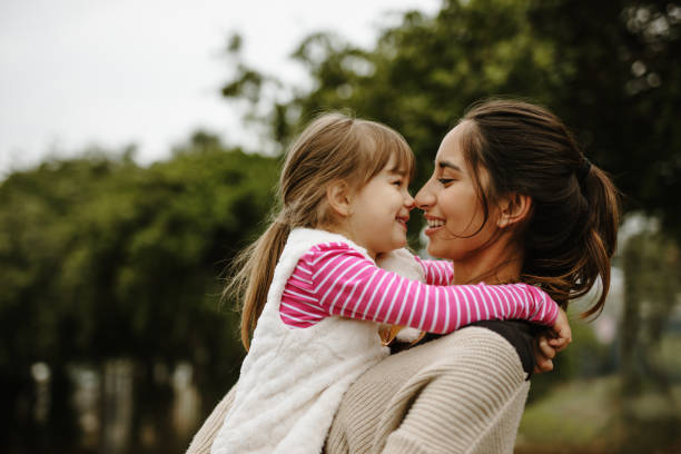 istock Babysitter with a girl at the park 1216342025