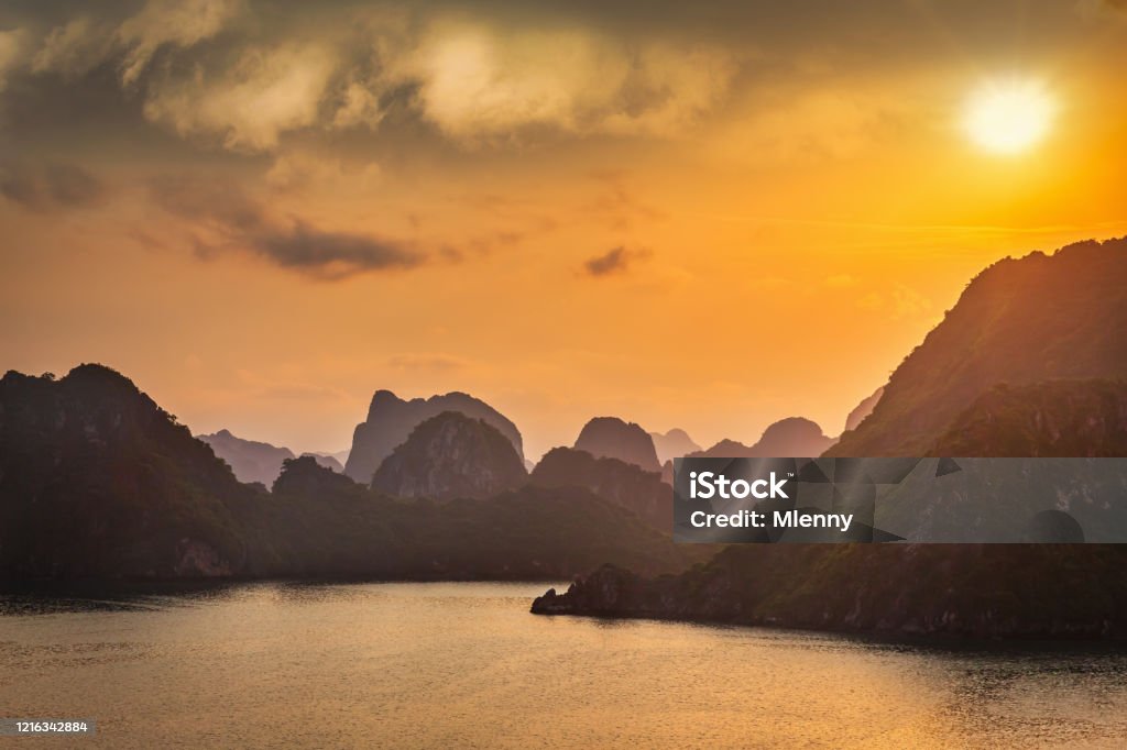 Halong Bay Sunset Twilight Vietnam Sunset Twilight over Halong Bay. Halong Bay is a UNESCO world heritage site and travel destination, popular for its fantastic limestone karsts and isles. Halong Bay, Quang Ninh Province, Northern Vietnam, Vietnam, Southeast Asia Hạ Long Bay Stock Photo
