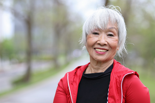 A beautiful white-haired senior woman in park