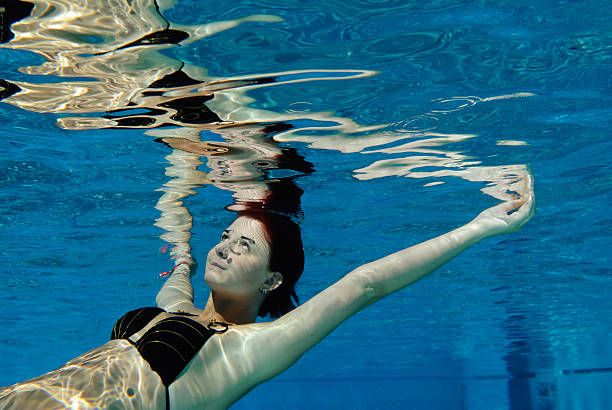 istock young woman floating in water 121634470