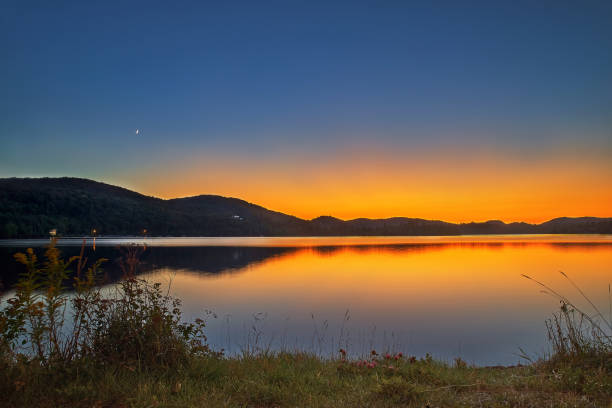 view of the Lac-Superieur, in Laurentides, Mont-Tremblant, Quebec, Canada, during the Indian summer at sunset view of the Lac-Superieur, in Laurentides, Mont-Tremblant, Quebec, Canada, during the Indian summer at sunset. indian summer stock pictures, royalty-free photos & images