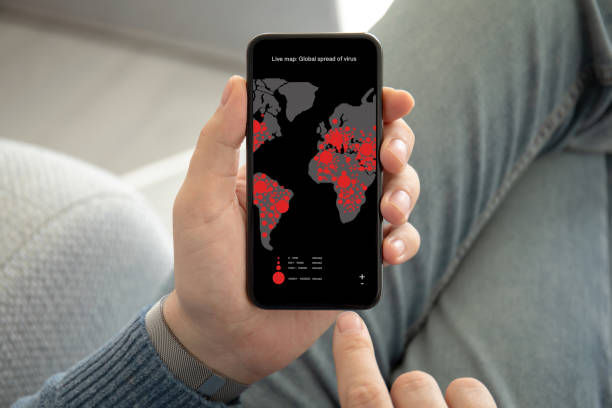 man hand holding phone live map global spread of virus