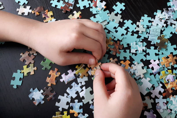 istock children's hands collect puzzles 1216347588