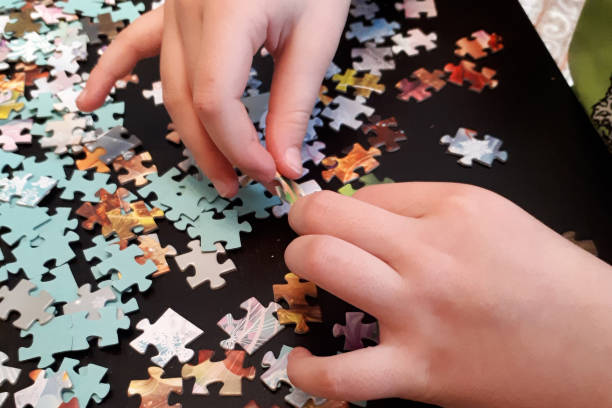 istock children's hands collect puzzles 1216347591