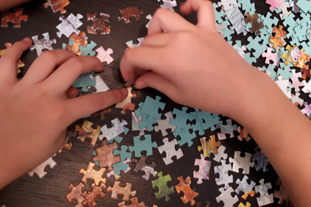istock children's hands collect puzzles 1216347605